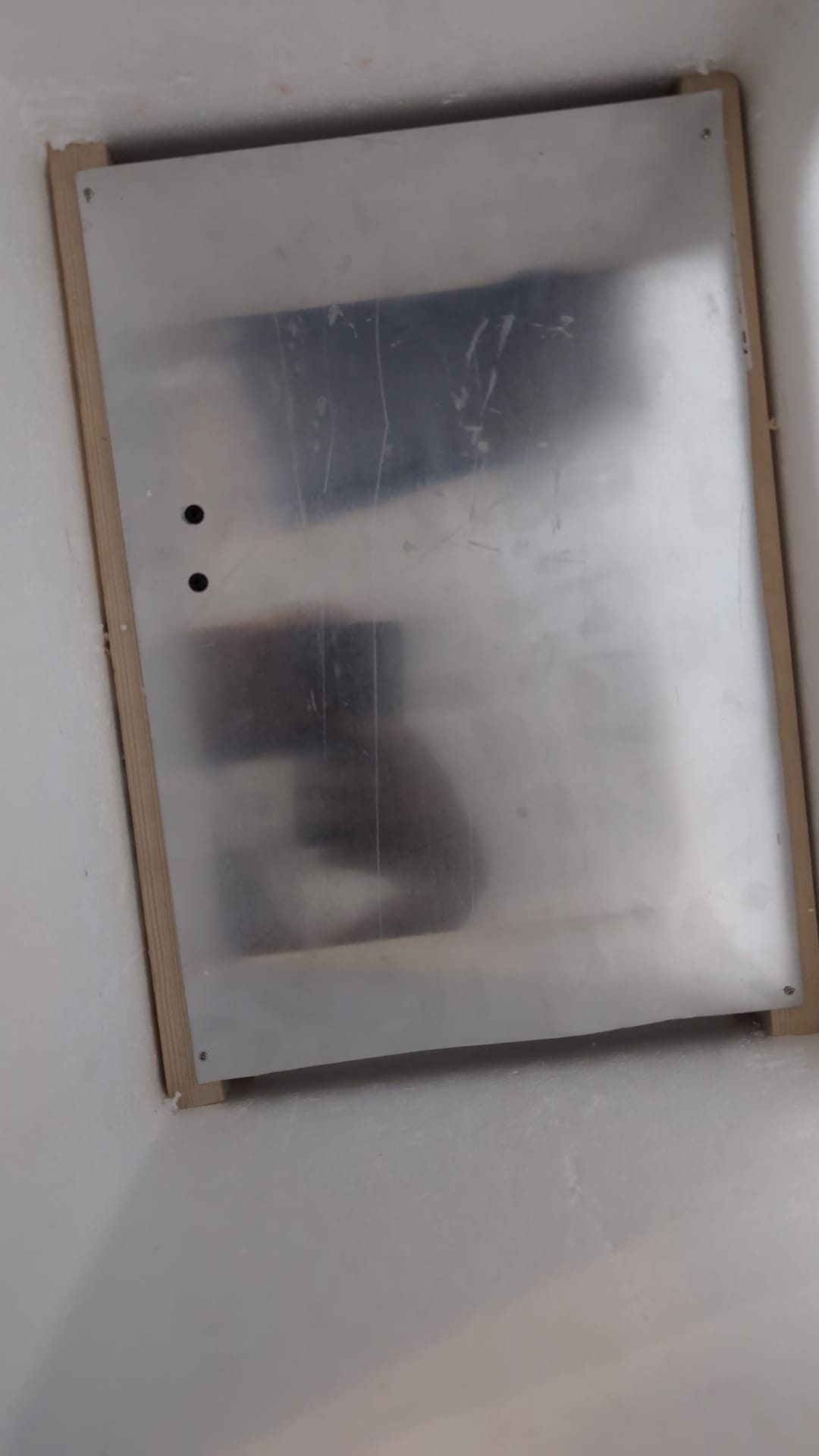 The aluminium plate screwed to a timber frame inside the polystyrene box